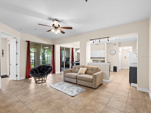 living room with light tile patterned floors and ceiling fan