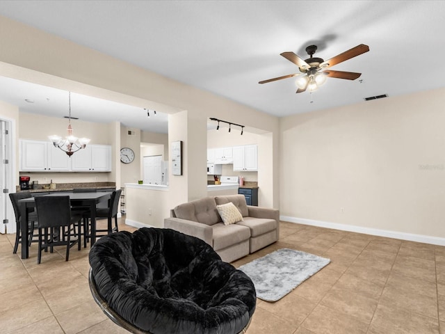 living room featuring light tile patterned floors, ceiling fan with notable chandelier, and rail lighting