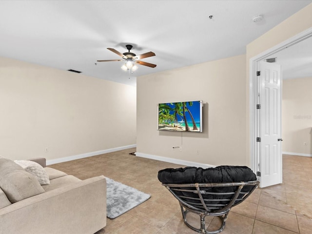 tiled living room featuring ceiling fan