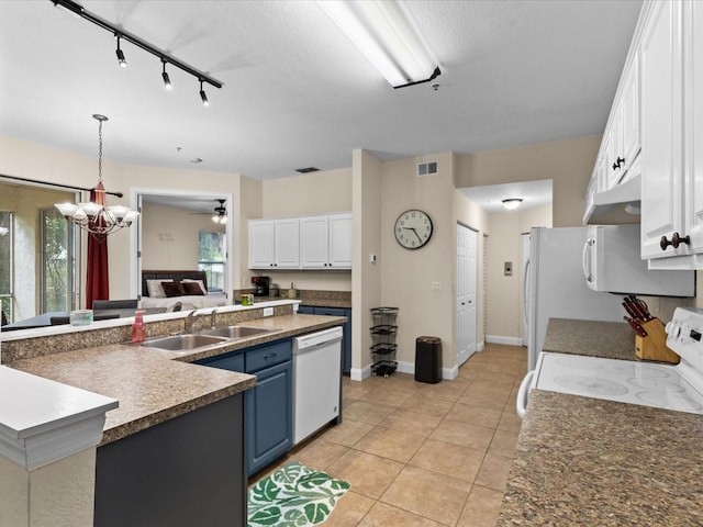 kitchen with blue cabinetry, white cabinetry, sink, and white appliances