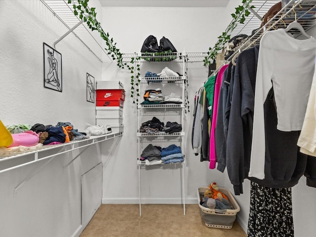 spacious closet featuring light tile patterned flooring