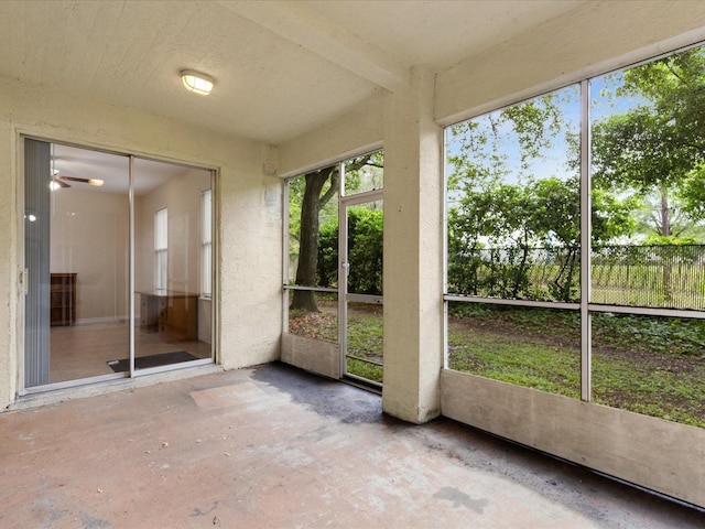 unfurnished sunroom featuring ceiling fan