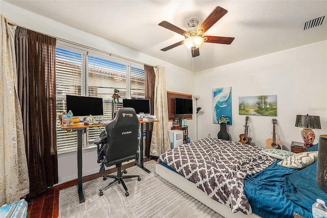 bedroom with ceiling fan and hardwood / wood-style floors