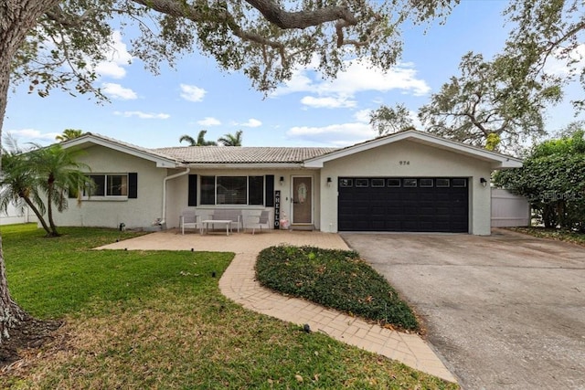 single story home with a garage and a front yard