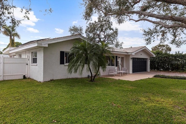 single story home featuring a front yard and a garage