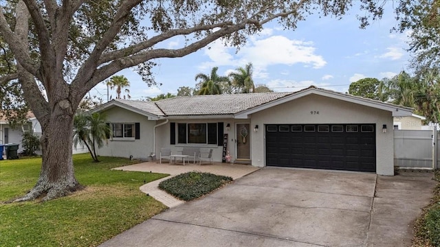 ranch-style home featuring a garage and a front yard