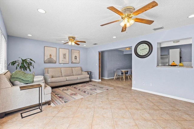 tiled living room with a textured ceiling