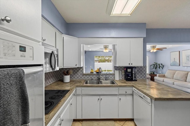 kitchen with sink, white appliances, white cabinetry, and light tile patterned flooring