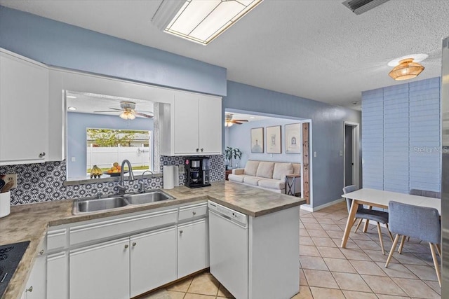 kitchen with tasteful backsplash, dishwasher, sink, and white cabinetry