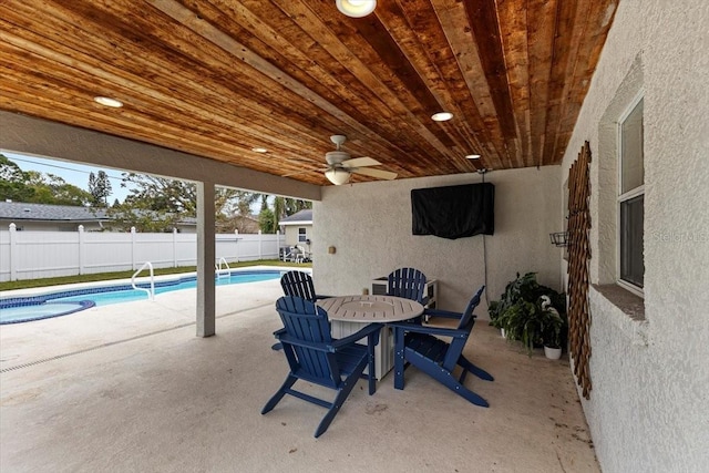 view of patio featuring ceiling fan and a fenced in pool