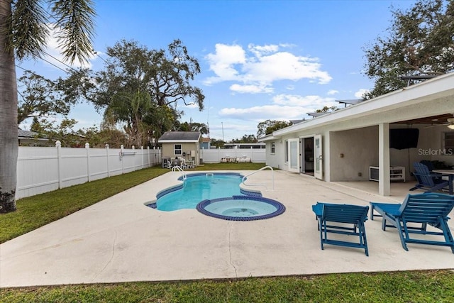 view of pool with a patio area and an in ground hot tub