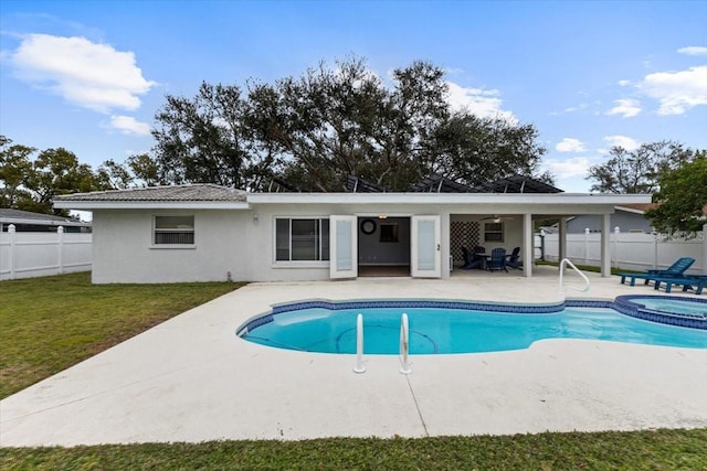 view of pool with a lawn, a patio area, and an in ground hot tub