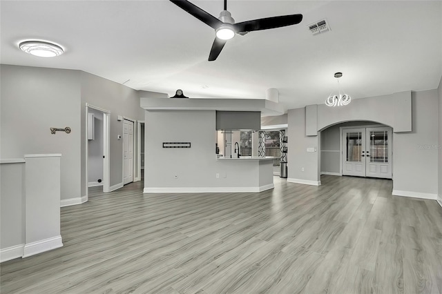 unfurnished living room with ceiling fan, light hardwood / wood-style flooring, french doors, and sink