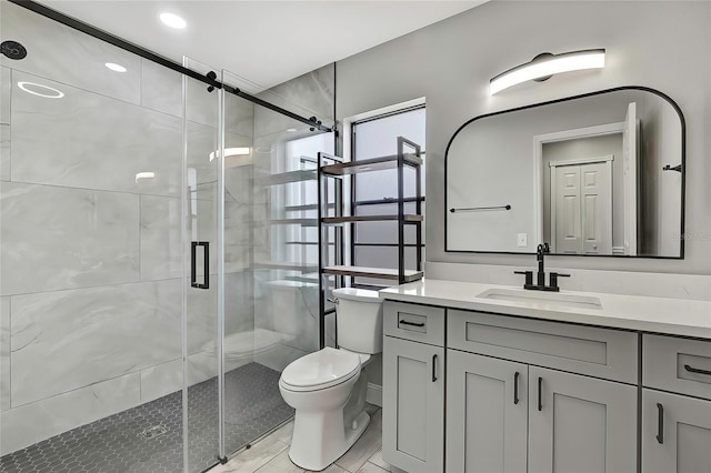 bathroom with vanity, toilet, and a shower with shower door