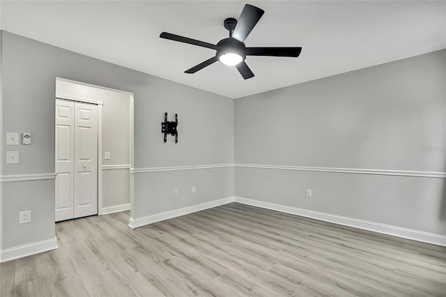 spare room featuring light hardwood / wood-style floors and ceiling fan