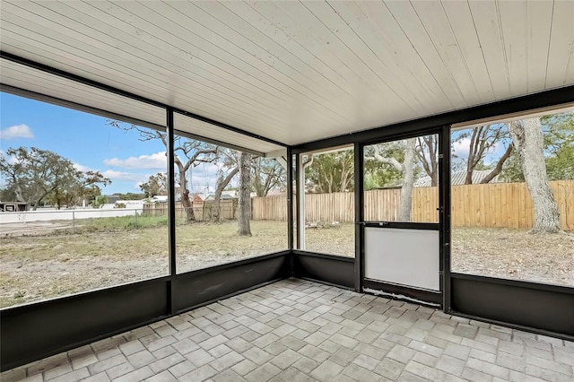 unfurnished sunroom with wooden ceiling