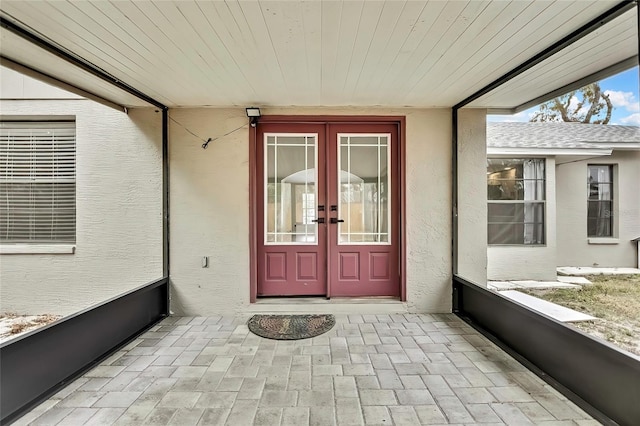 view of exterior entry featuring french doors