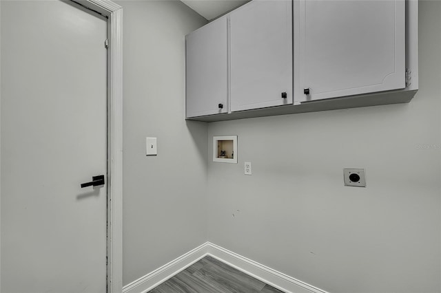 clothes washing area with hookup for an electric dryer, cabinets, hardwood / wood-style floors, and hookup for a washing machine