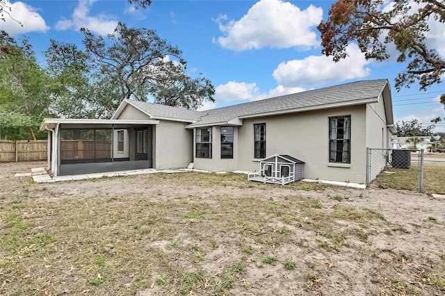 rear view of house featuring a sunroom