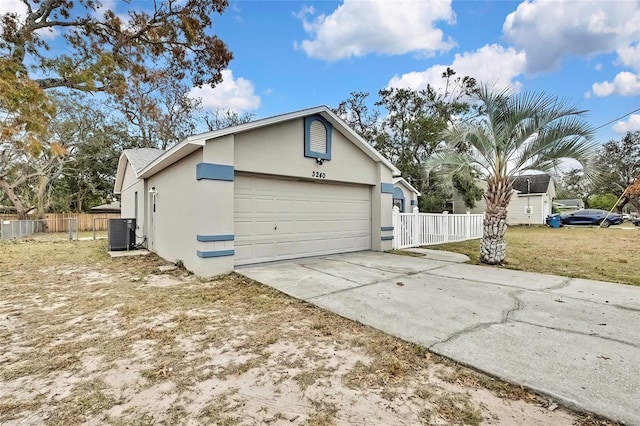 view of side of property featuring cooling unit and a garage