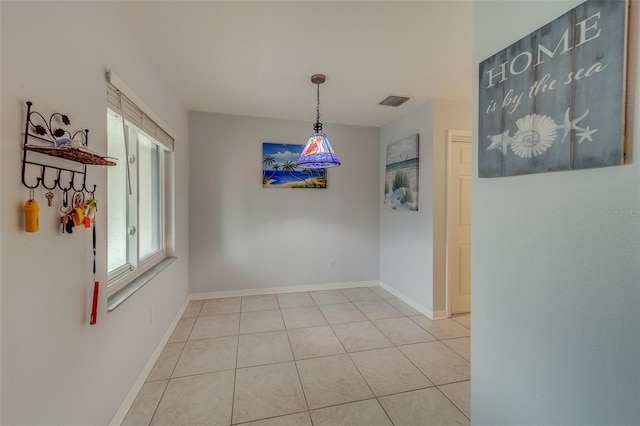 unfurnished dining area with light tile patterned floors