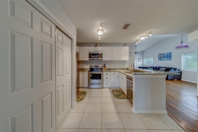 kitchen featuring white cabinetry, stainless steel appliances, sink, kitchen peninsula, and light tile patterned floors