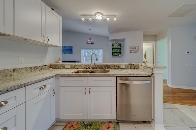 kitchen with stainless steel dishwasher, kitchen peninsula, sink, light tile patterned floors, and white cabinets