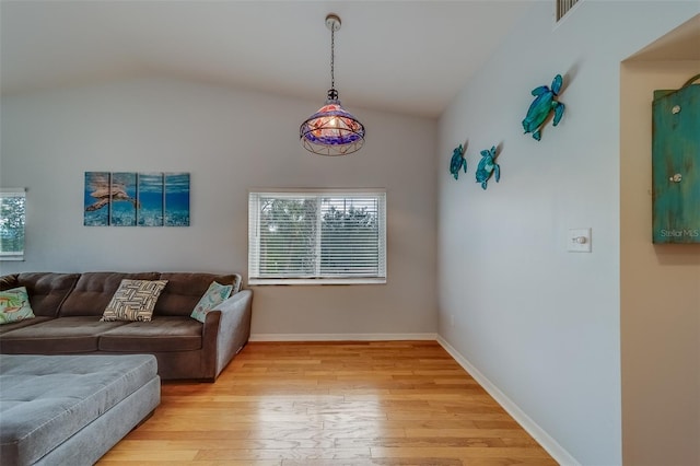 living room with lofted ceiling and light hardwood / wood-style floors