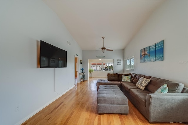 living room featuring light hardwood / wood-style floors, ceiling fan, and vaulted ceiling