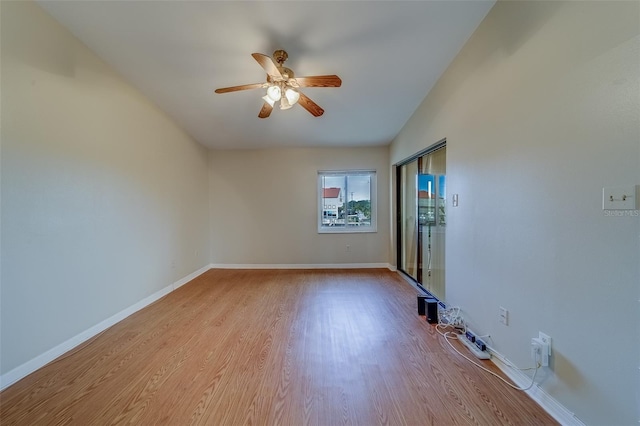 spare room featuring ceiling fan, vaulted ceiling, and light wood-type flooring