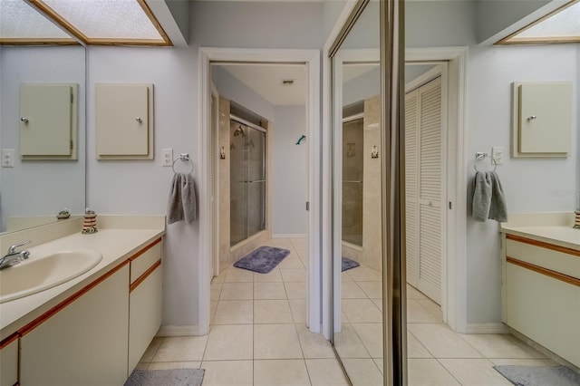 bathroom with walk in shower, tile patterned floors, and vanity