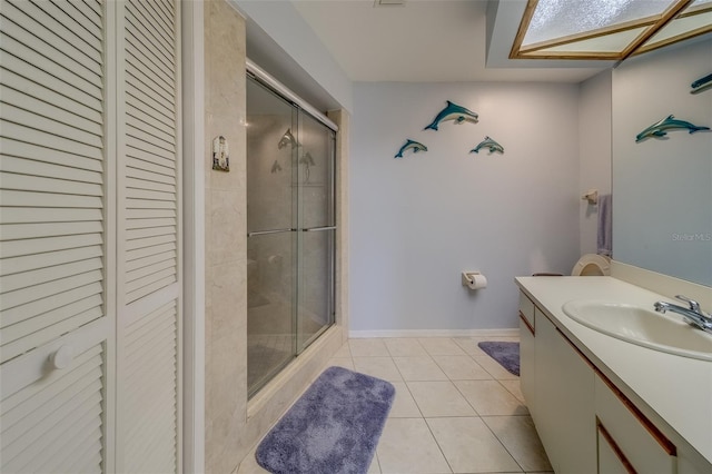 bathroom with vanity, tile patterned flooring, and a shower with door