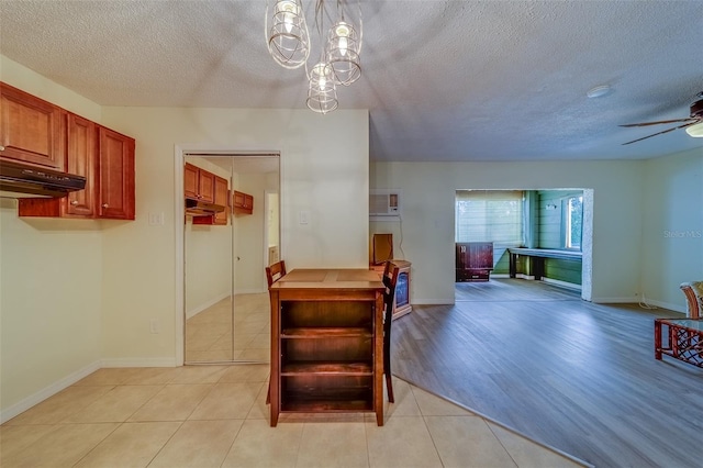 interior space with ceiling fan and a textured ceiling