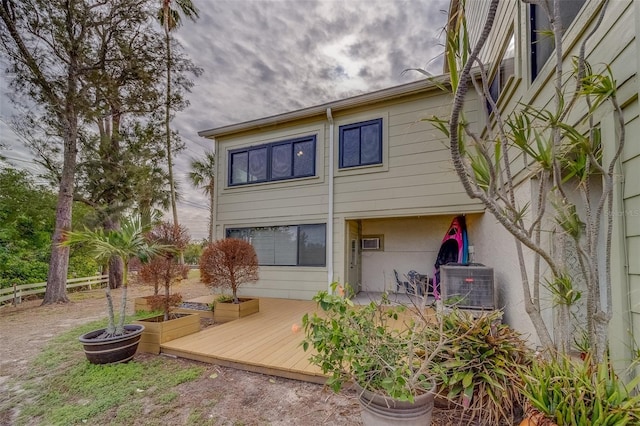 back of property featuring cooling unit and a deck