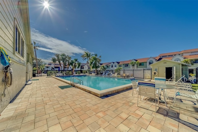 view of pool featuring a patio area and a shed