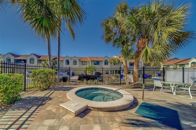 view of pool with a hot tub and a patio area