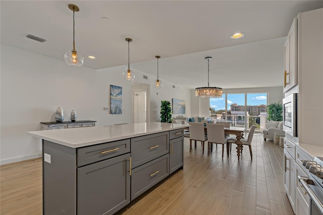 kitchen with pendant lighting, gray cabinets, and a center island