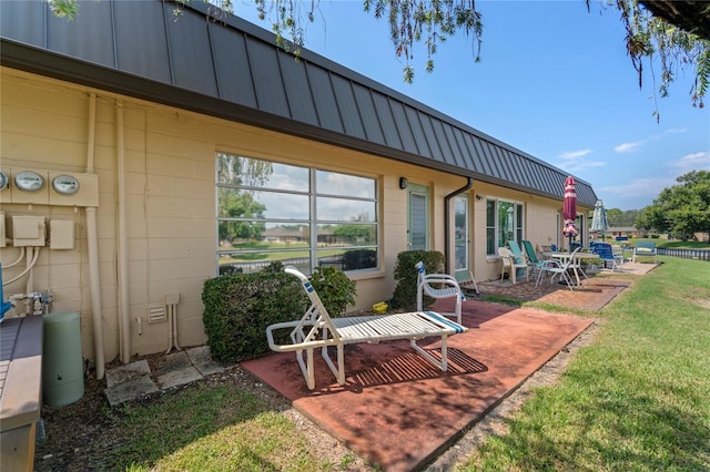 back of property featuring a yard and a patio area