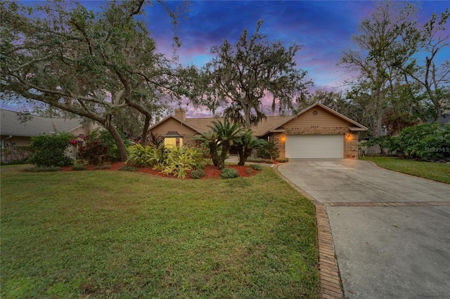 ranch-style home with a yard and a garage