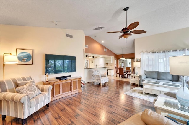 living room featuring a wealth of natural light, ceiling fan, dark hardwood / wood-style floors, and lofted ceiling