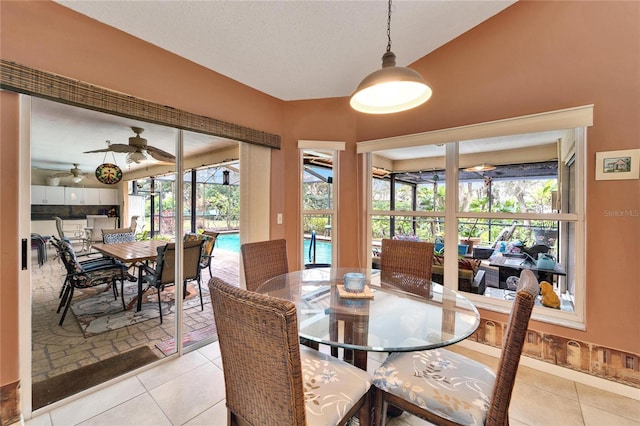 dining room featuring ceiling fan, light tile patterned flooring, and a wealth of natural light