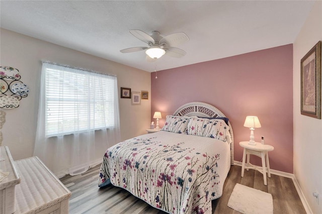 bedroom featuring hardwood / wood-style floors and ceiling fan