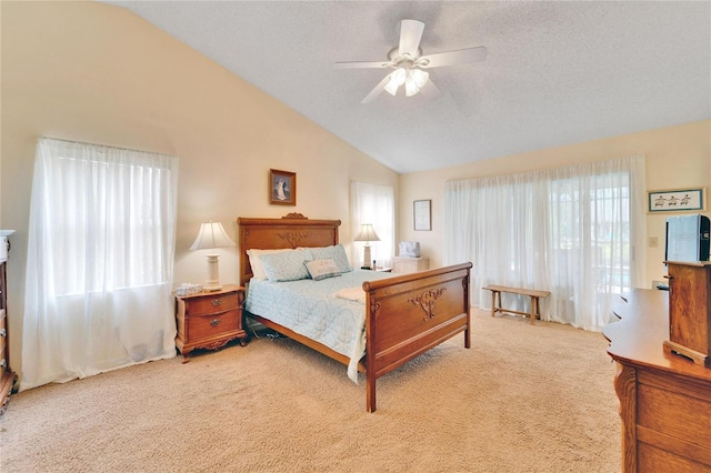 bedroom featuring a textured ceiling, ceiling fan, light colored carpet, and lofted ceiling