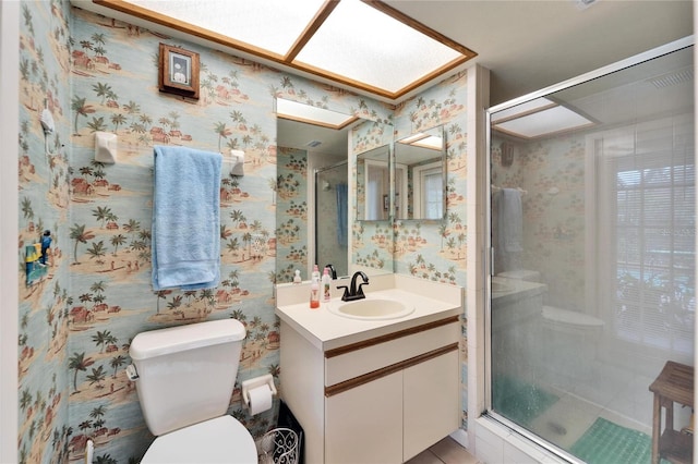 bathroom with walk in shower, vanity, and toilet