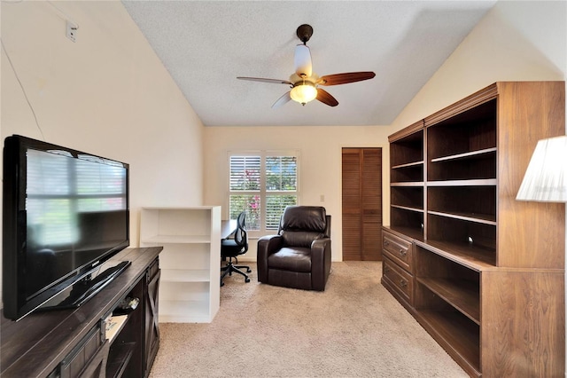 office with a textured ceiling, ceiling fan, lofted ceiling, and light carpet