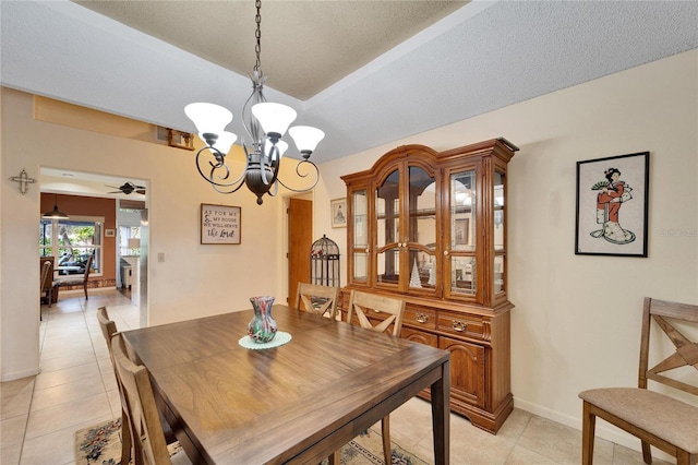 tiled dining area featuring ceiling fan with notable chandelier