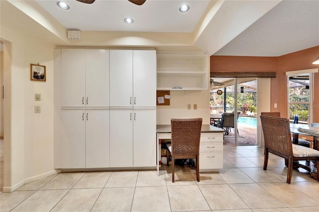 home office featuring ceiling fan and light tile patterned floors