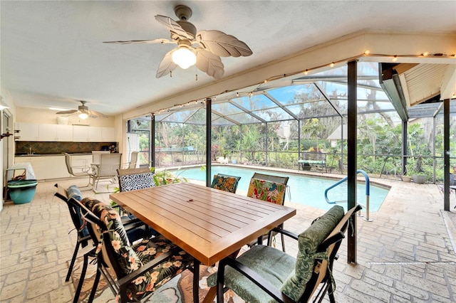 interior space with ceiling fan, an outdoor bar, and glass enclosure