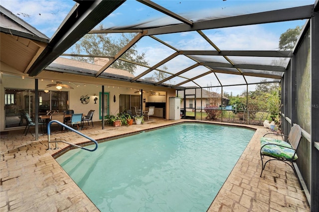 view of pool with a lanai, a patio area, and ceiling fan