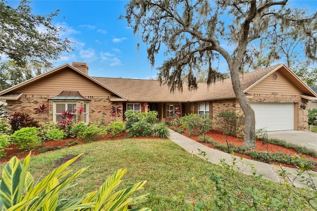 single story home with a front yard and a garage